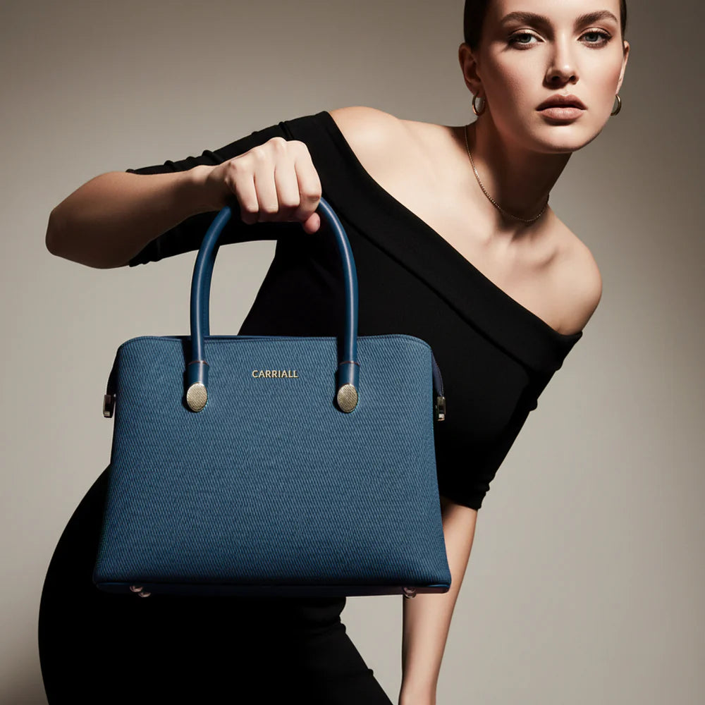 A structured blue tote carried for a polished modern look